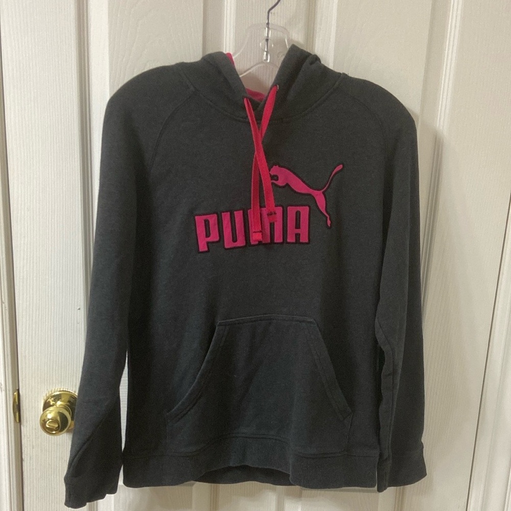 Stylish Puma hoodie. Features a bold pink logo. Comfortable and trendy.